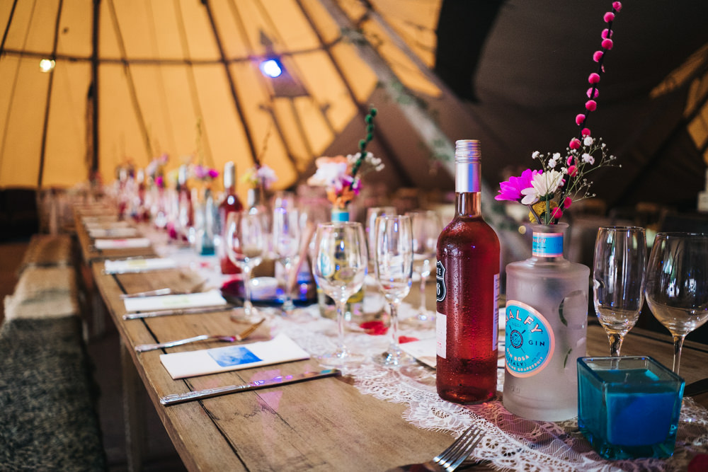Tipi Long Wooden Tables Colourful Bottles Flowers Hammer and Pincers Wedding Sally T Photography