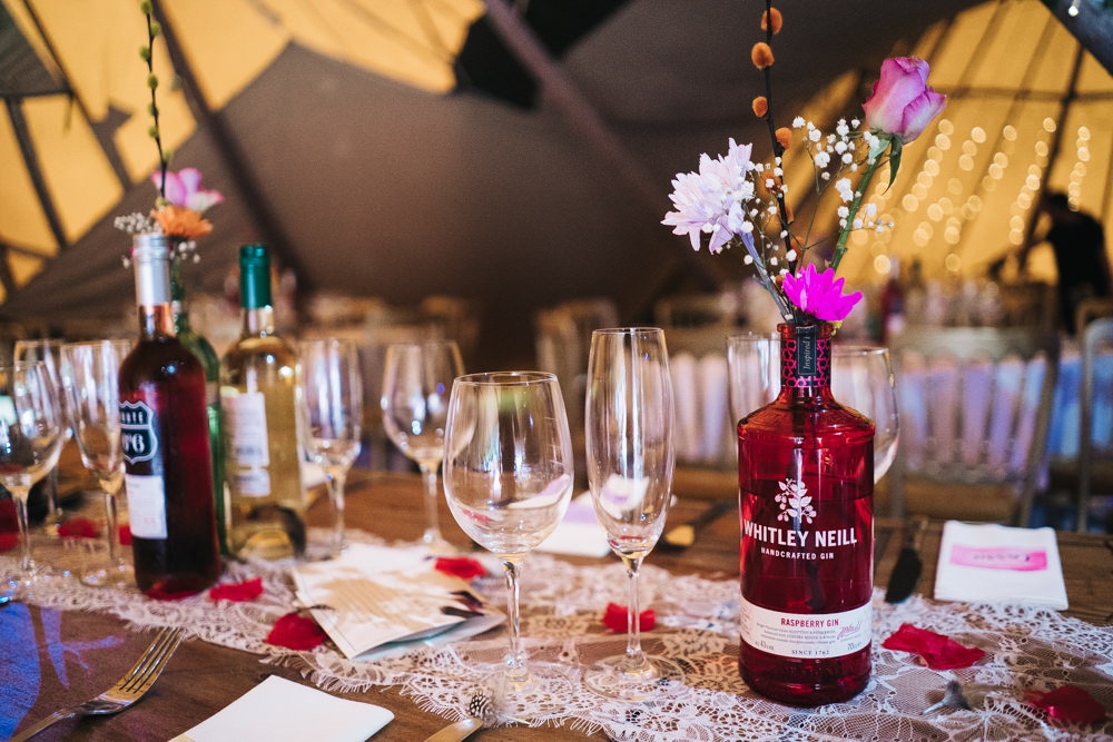 Tipi Long Wooden Tables Colourful Bottles Flowers Hammer and Pincers Wedding Sally T Photography