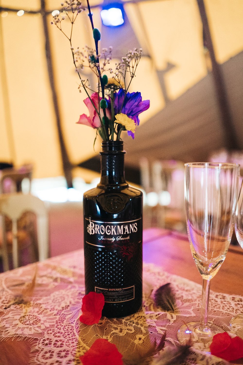 Tipi Long Wooden Tables Colourful Bottles Flowers Hammer and Pincers Wedding Sally T Photography