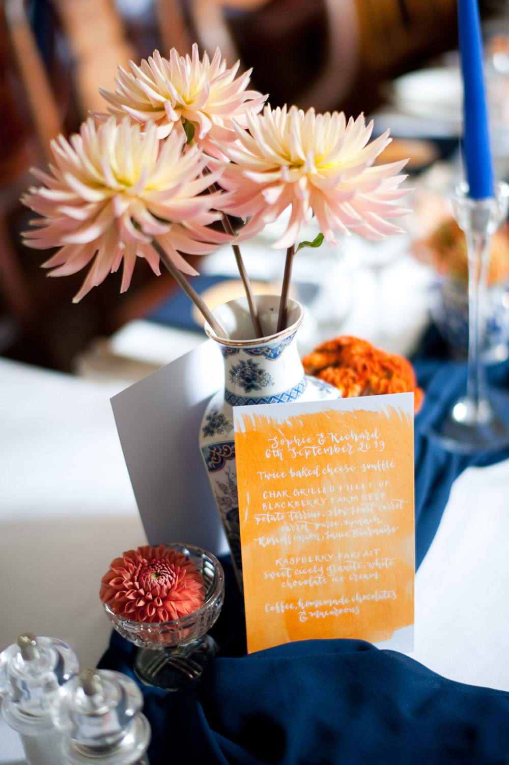 Coral Orange Dahlias Centrepiece Flowers Table Candles Blue Cloth Table Name Floral Wedding Rachael Connerton Photography
