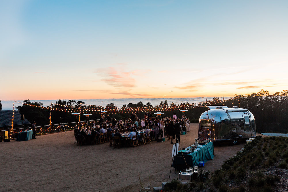 Outdoor Reception Long Wooden Tables Festoon Lights Pacific Coast Wedding Mallory Miya Photography