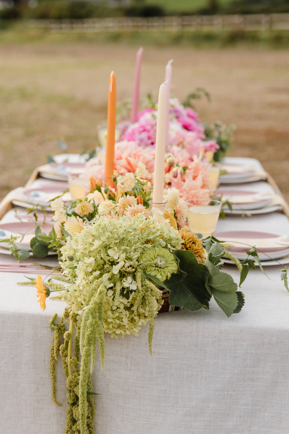 Table Tablescape Decor Flowers Ombre Pink Orange Yellow Candles Rainbow Wedding Ideas Michelle Huggleston Photography