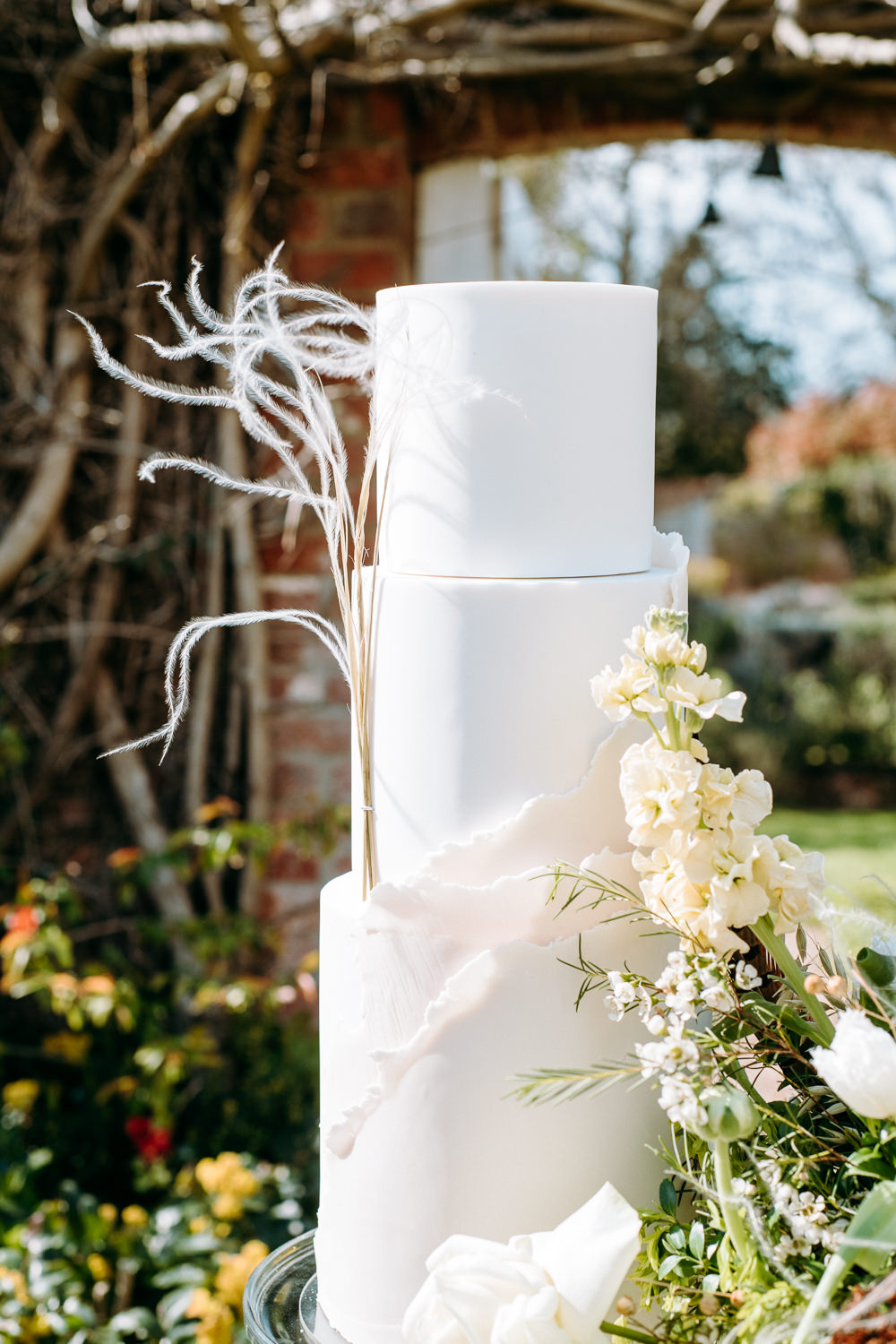 Iced White Cake Feather Flowers Countryside Elopement Chloe Martin Photo