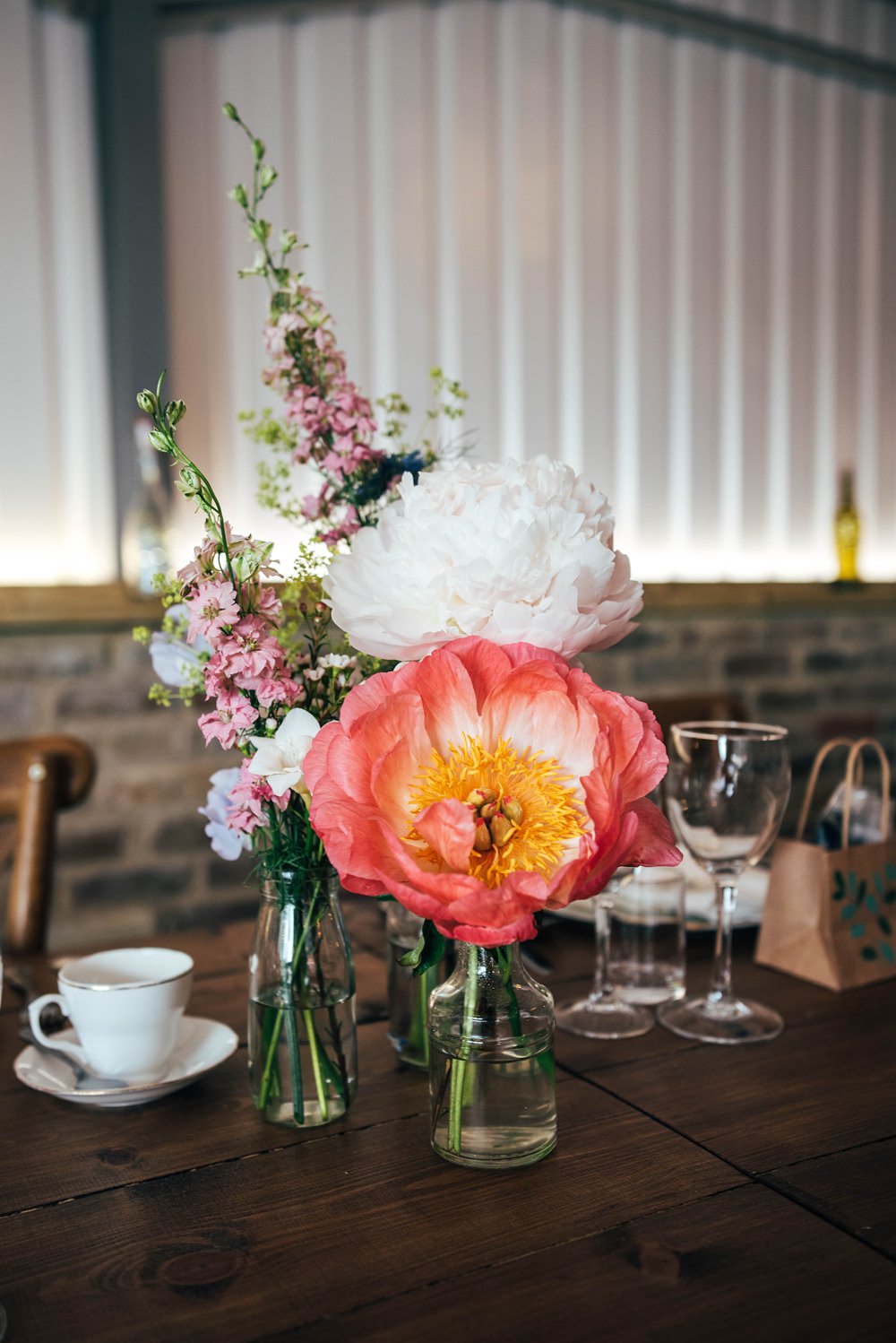 Glass Bottle Centrepiece Flowers Coral Charm Peony Essex Barn Wedding Three Flowers Photography