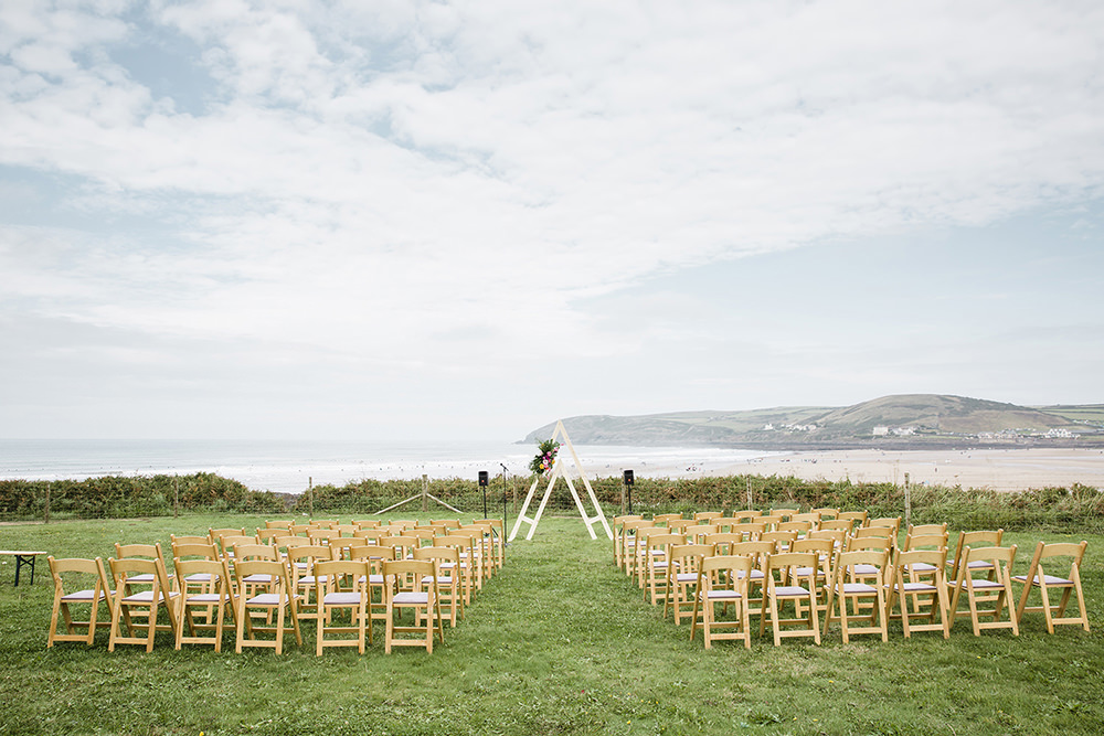 Tiki Wedding AW Wedding Photography Outdoor Ceremony Beach Sea Triangle Arch Backdrop Flowers