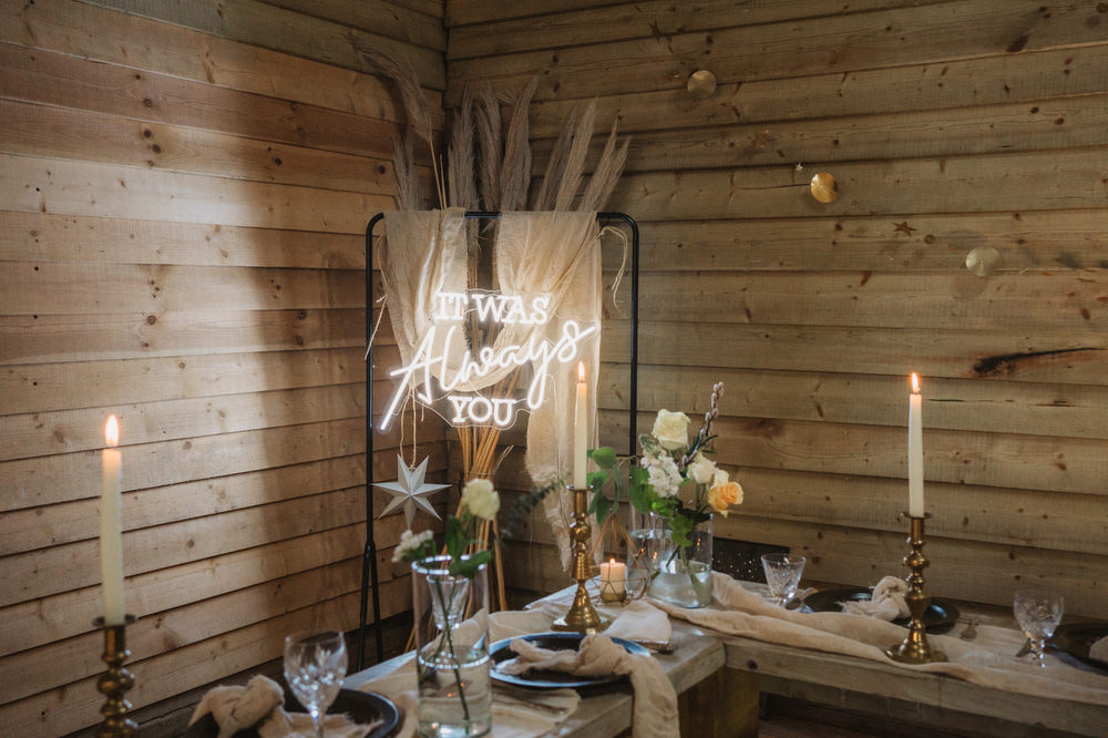 Neon Sign Backdrop Log Cabin Barn Decor Stars Cosy Scandi Wooden Tables Greenery Upthorpe Wood Wedding Emily Tyler Photography