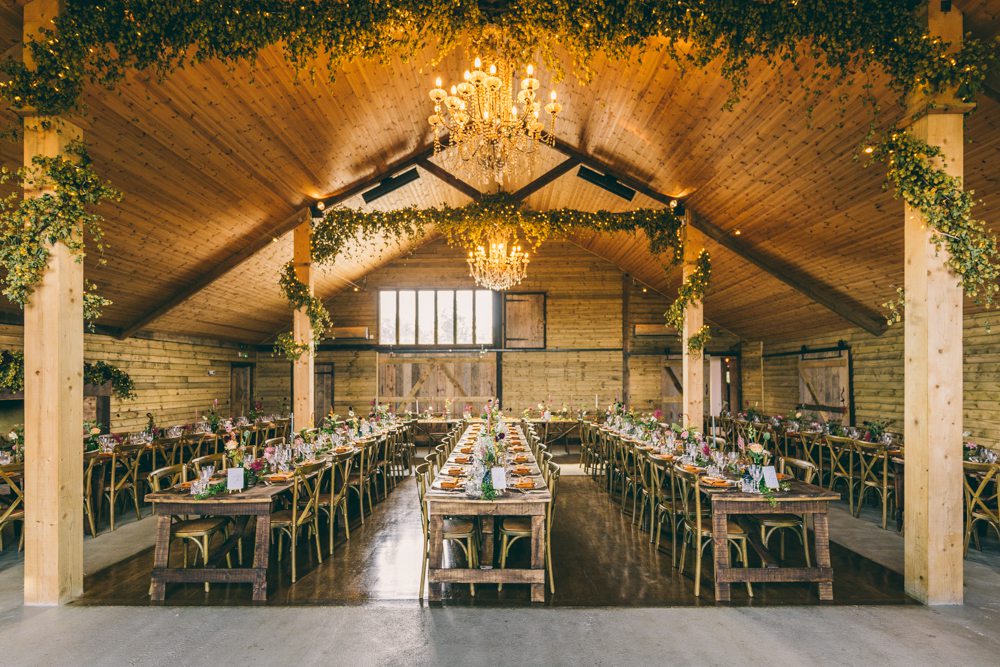 Barn Reception Lighting Greenery Long Wooden Tables Surrey Farm Wedding Rob Tarren Photography