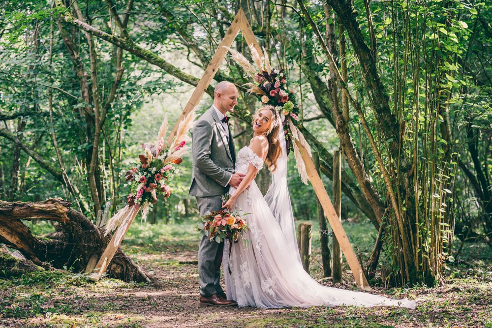 Surrey Farm Wedding Rob Tarren Photography Woodland Ceremony Rug Aisle Pampas Grass Triangle Arch Backdrop
