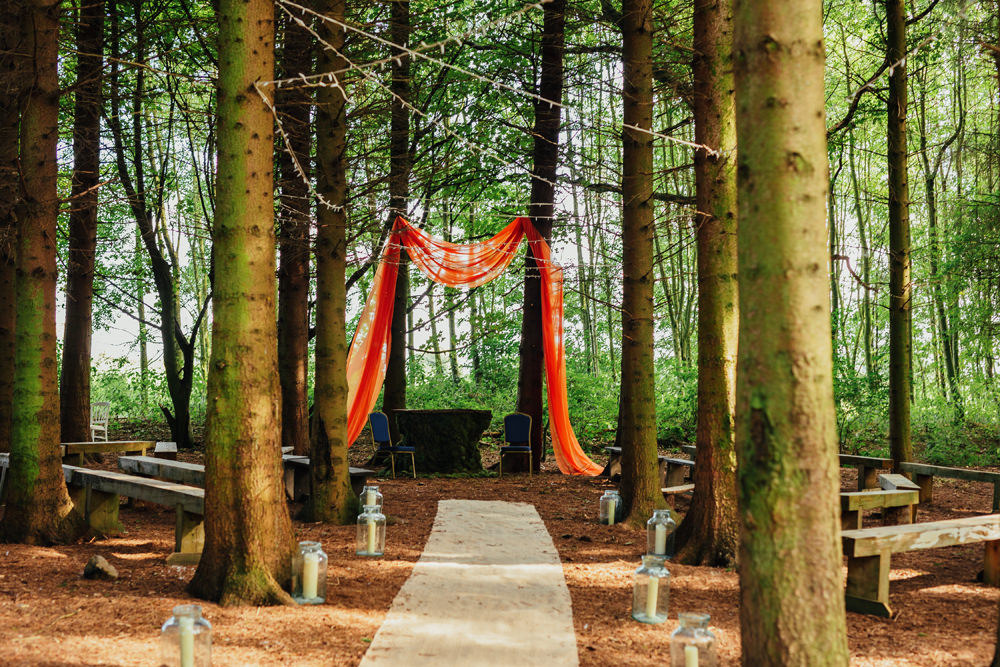 Woodland Aisle Ceremony Candles Orange Fabric Arch Yorkshire Woodland Wedding James and Lianne