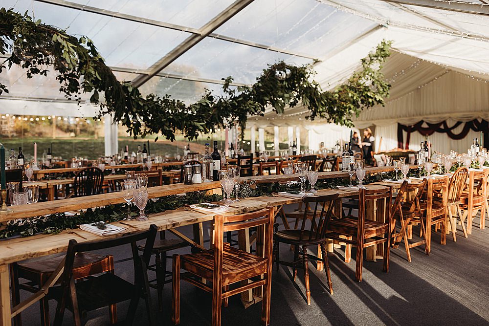 Clear Marquee Greenery Swag Fairy Lights Wooden Long Tables Clophill Eco Lodges Wedding ThymeLane Photography