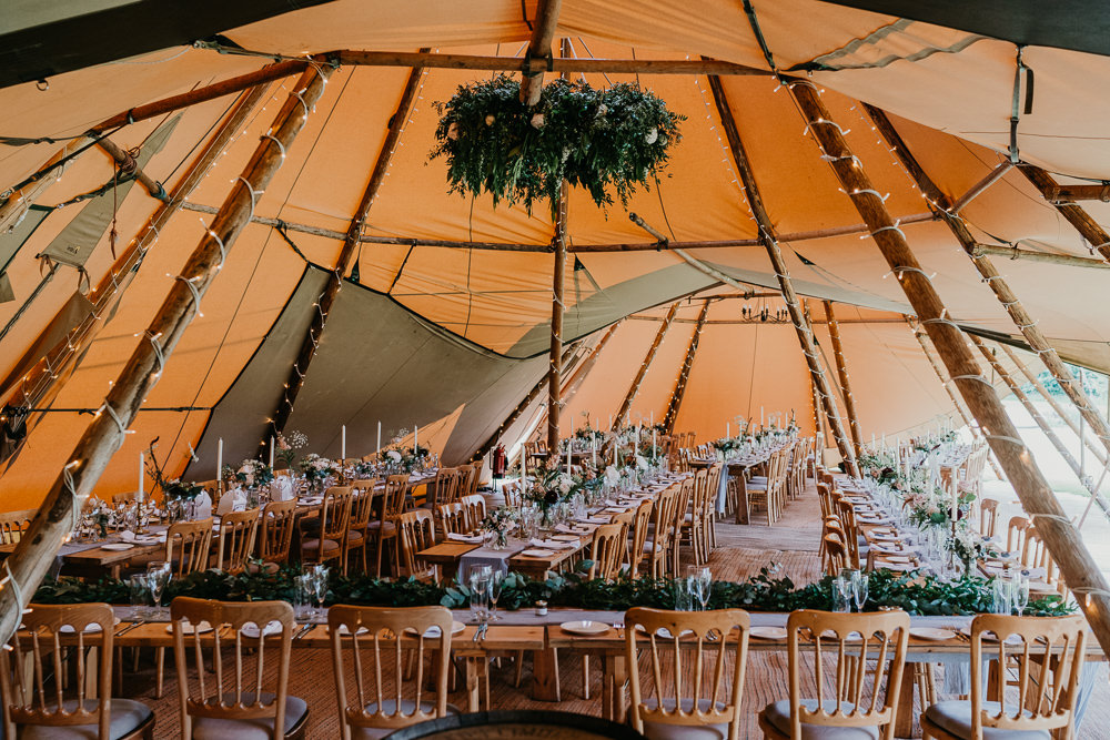 Tipi Decor Long Wooden Tables Greenery Hertfordshire Farm Wedding Jonny Gouldstone Photography