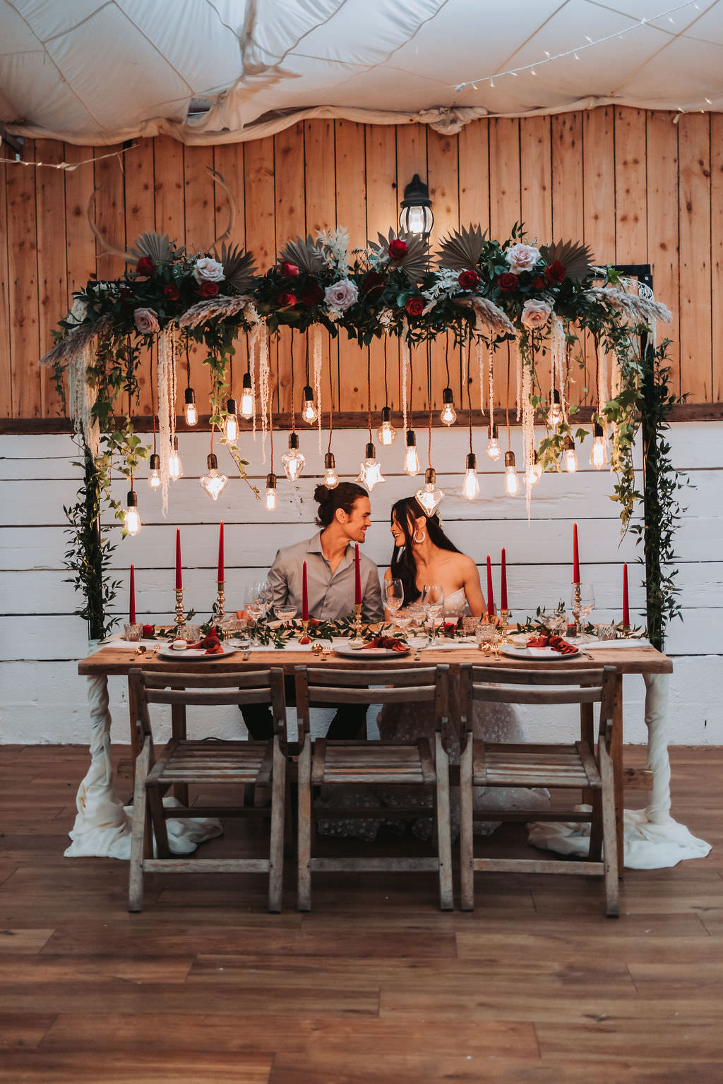Festoon Lighting Wooden Table Red Candles Napkins Greenery Decor Bold Wedding Ideas Pasha Jansen Photography