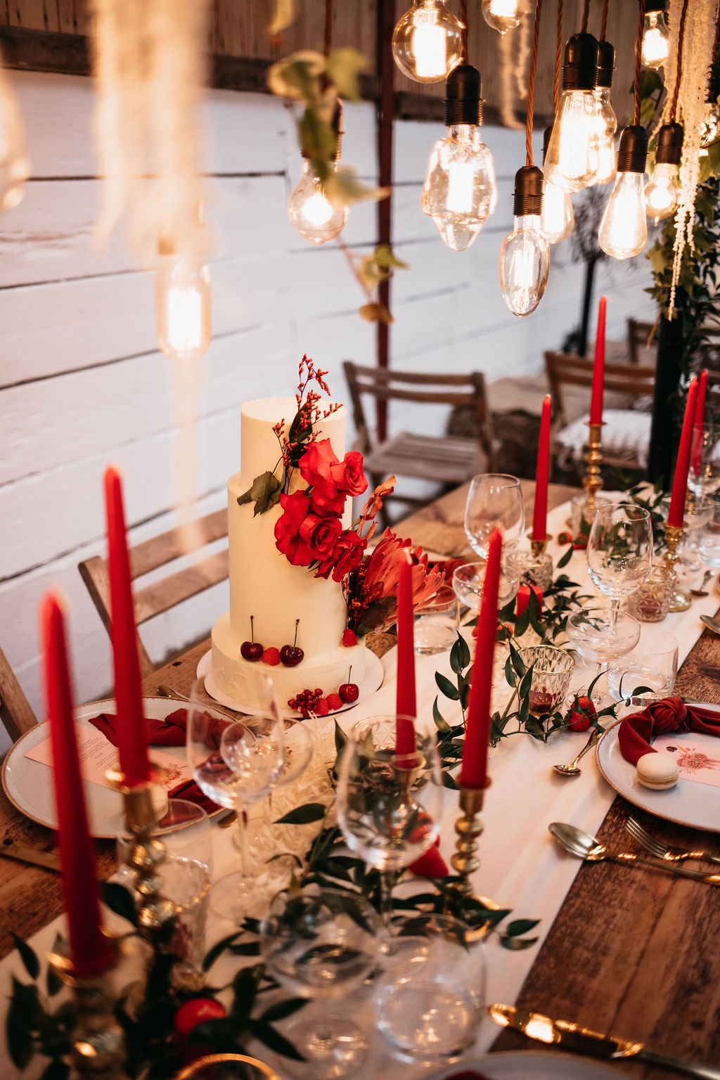 Festoon Lighting Wooden Table Red Candles Napkins Greenery Decor Bold Wedding Ideas Pasha Jansen Photography