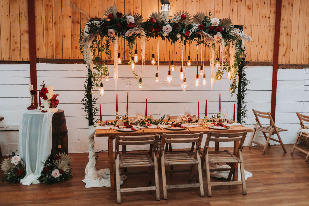 Festoon Lighting Wooden Table Red Candles Napkins Greenery Decor Bold Wedding Ideas Pasha Jansen Photography