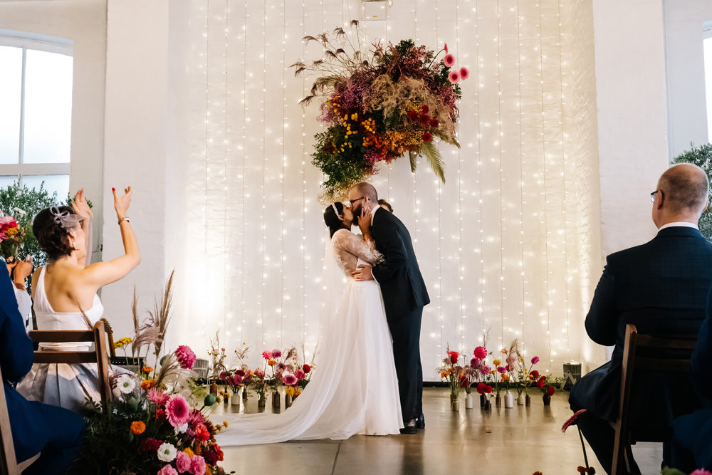 Ceremony Flowers Colourful Fairy Light Wall London Warehouse Wedding Kristian Leven Photography