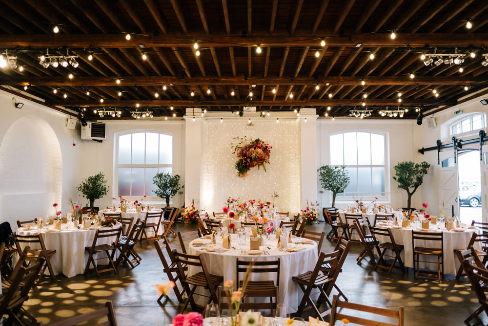 Decor Reception Colourful Flowers Festoon Lights London Warehouse Wedding Kristian Leven Photography