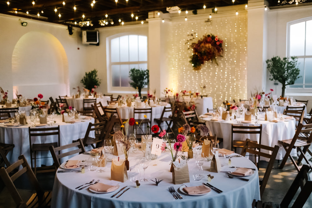 Decor Reception Colourful Flowers Festoon Lights London Warehouse Wedding Kristian Leven Photography
