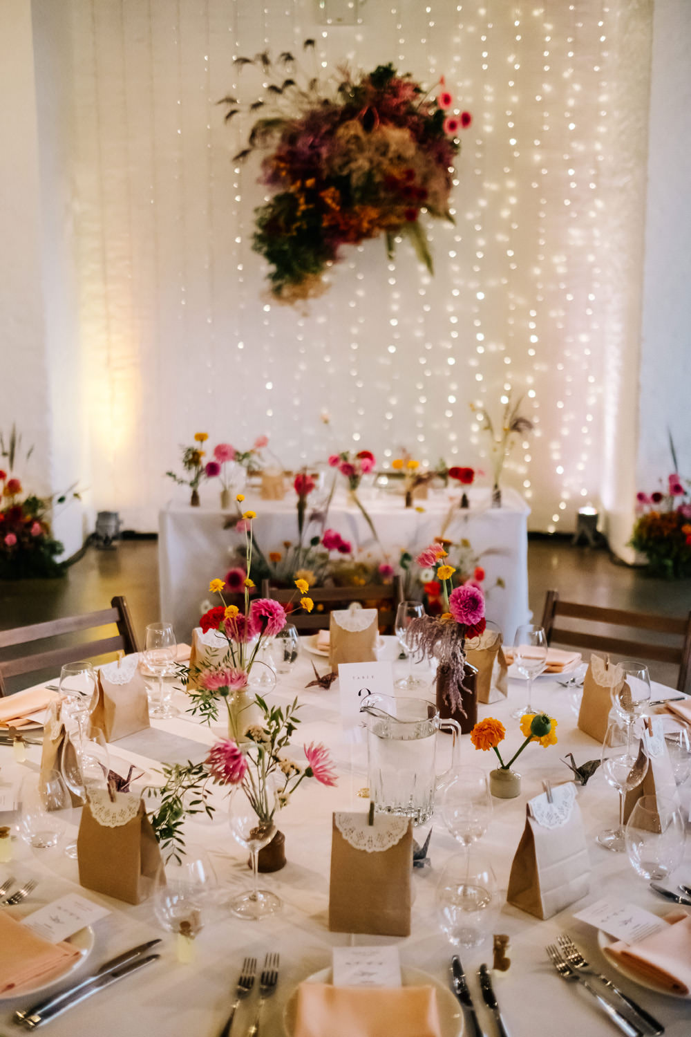 Decor Reception Colourful Flowers Festoon Lights Tables London Warehouse Wedding Kristian Leven Photography