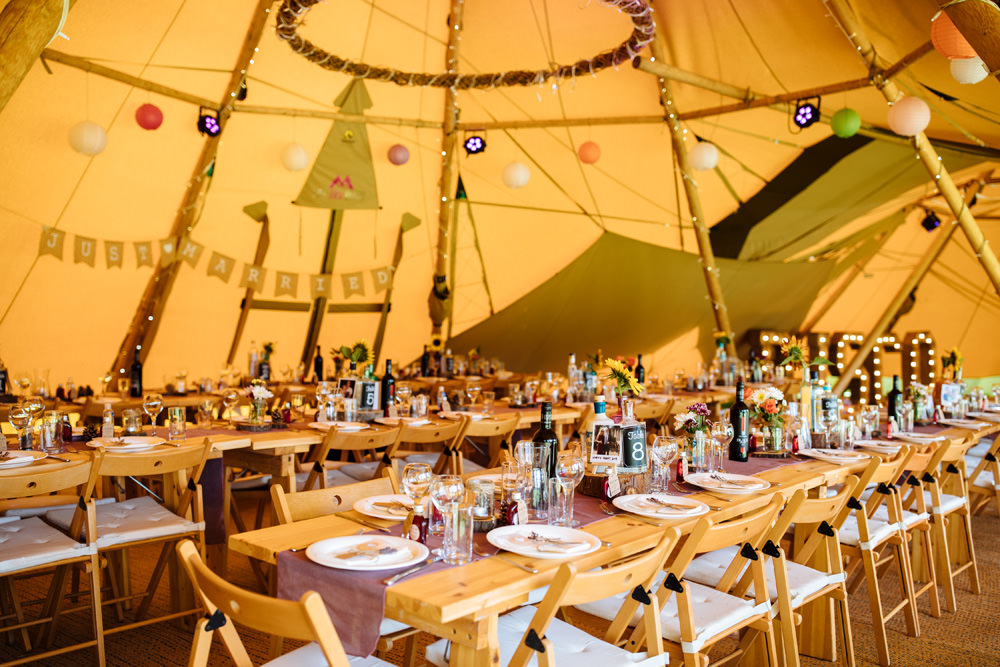 Tipi Reception Decor Lanterns Bunting Long Wooden Tables Lynsted Park Wedding Laura Debourde Photography