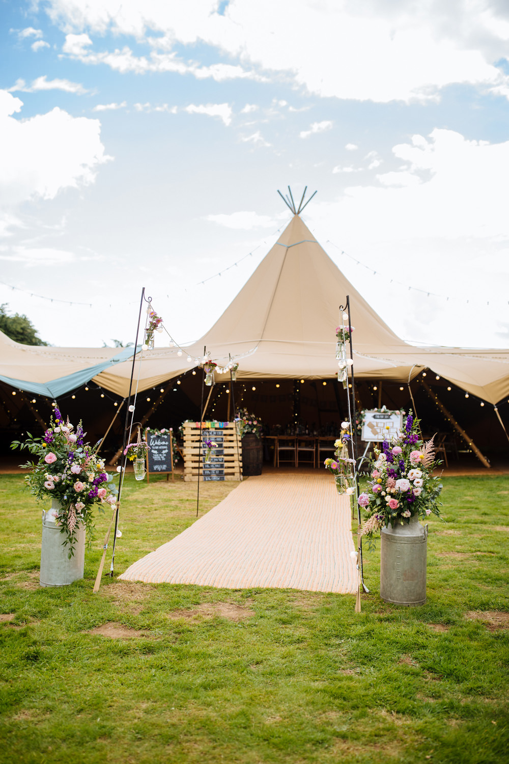 Tipi Reception Aisle Flowers Festoon Lights Lynsted Park Wedding Laura Debourde Photography
