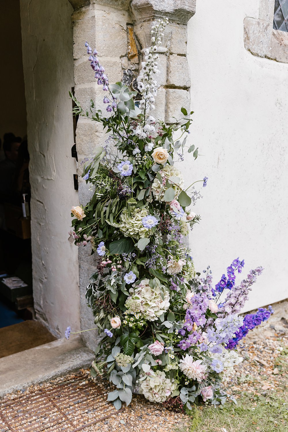 Church Door Flower Installation Lilac Pink Delphinium Hydrangea Barnston Lodge Wedding Katherine Ashdown Photography