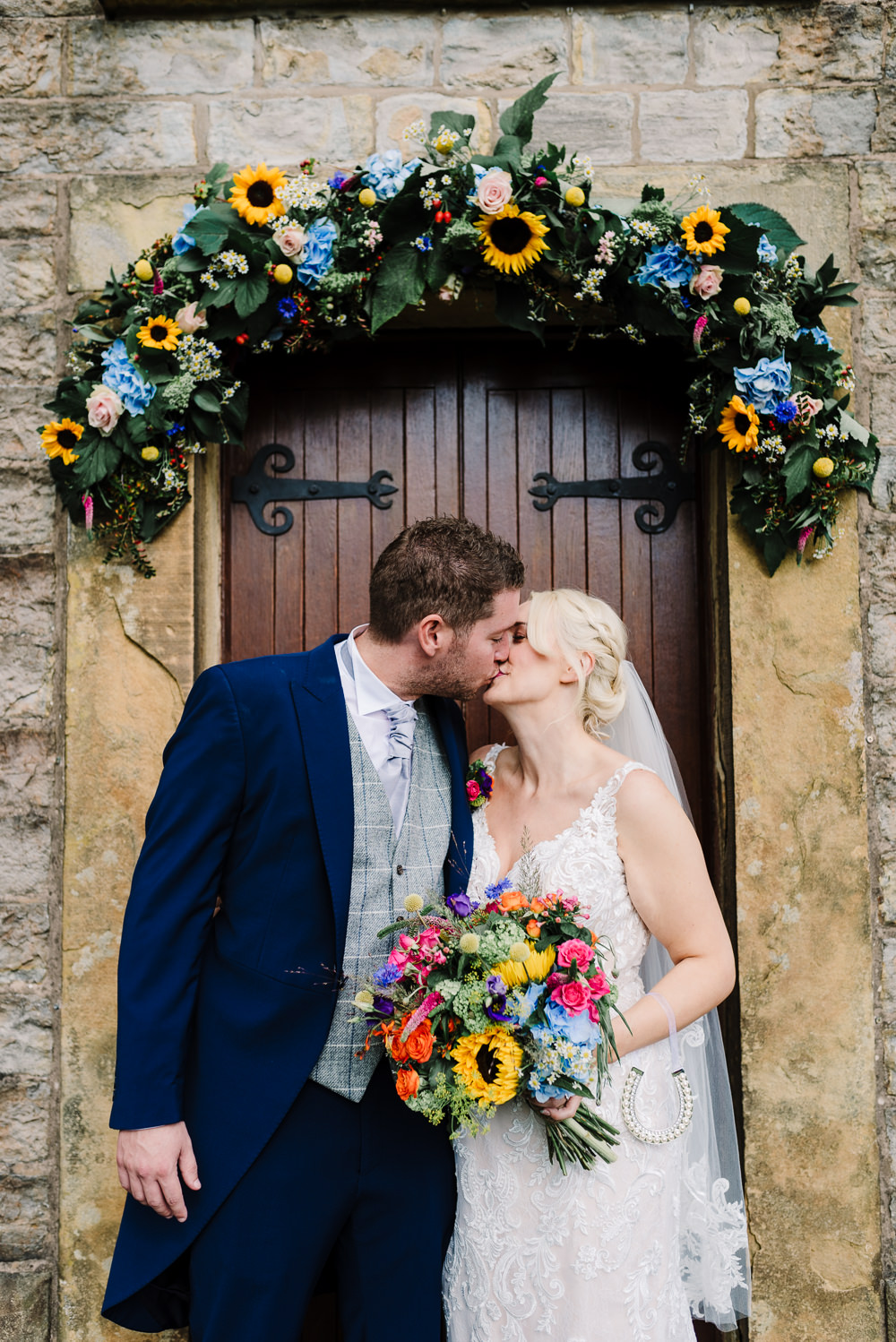 Floral Church Door Decoration Colourful Flowers Bouquet Daisy Hydrangea Rose Sunflower Bashall Barn Wedding Rachel Kenyon Photography