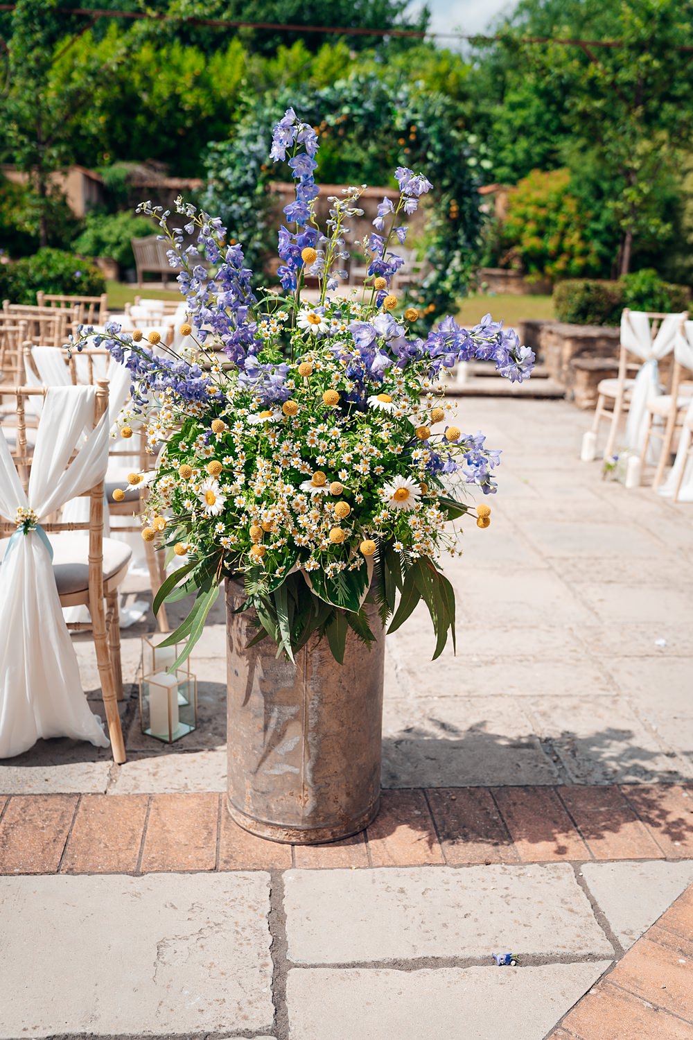 Milk Churn Flowers Arrangement Craspedia Daisies Delphiniums Blue Yellow Wedding Ideas EmilyCollettPhotography