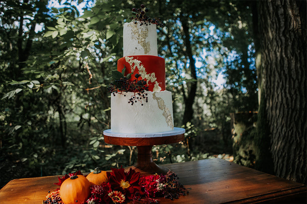 Three Tier Cake Orange Gold Leaf Sustainable Woodland Wedding Charly Mae Photography