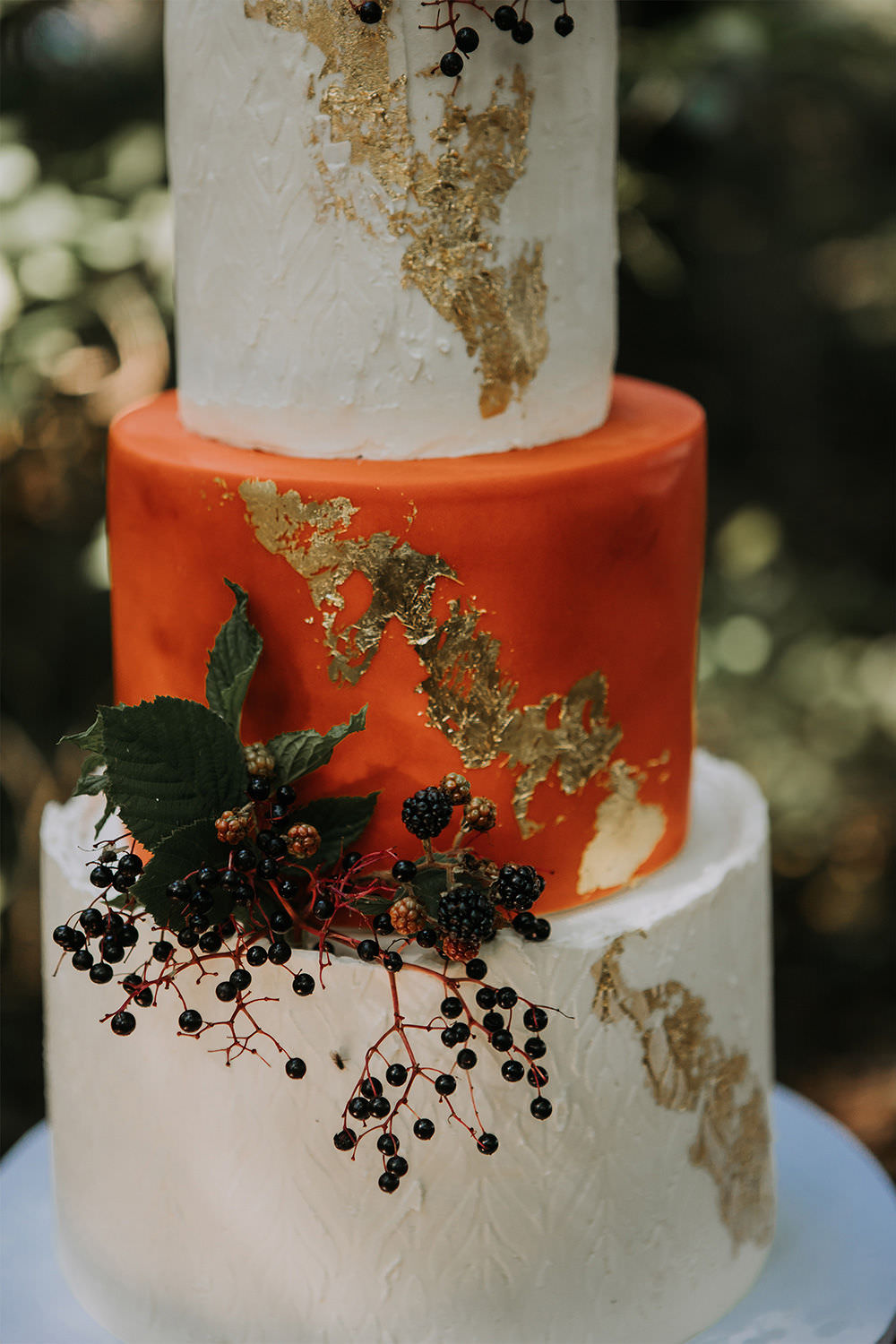 Three Tier Cake Orange Gold Leaf Sustainable Woodland Wedding Charly Mae Photography