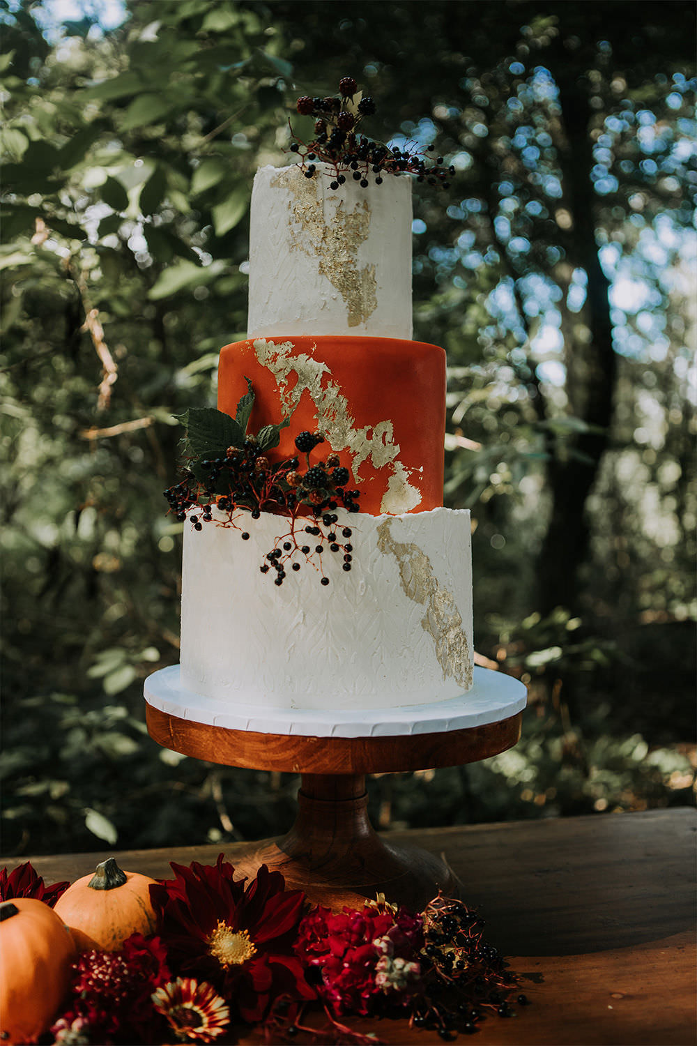 Three Tier Cake Orange Gold Leaf Sustainable Woodland Wedding Charly Mae Photography