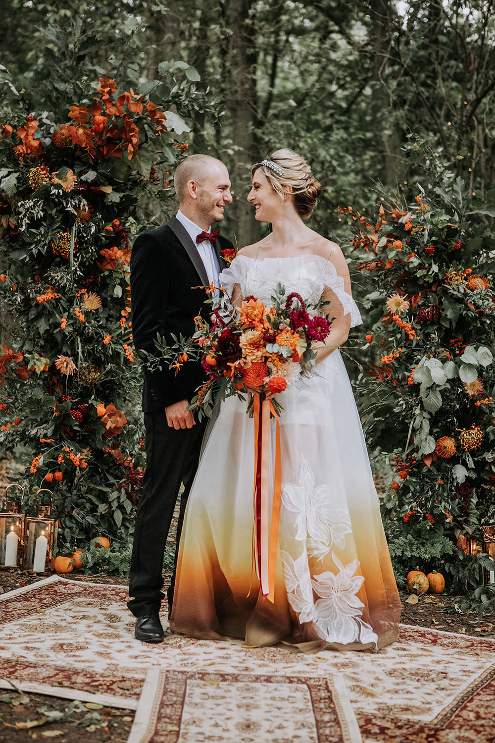 Flower Arch Installation Rug Aisle Ceremony Autumn Sustainable Woodland Wedding Charly Mae Photography Dip Dye Ombre Dress Orange Gown Bride Bridal