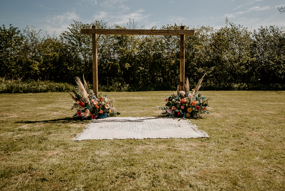 Ceremony Arch Backdrop Flowers Rug Decor Bohemian Tipi Wedding MattMoore Photography