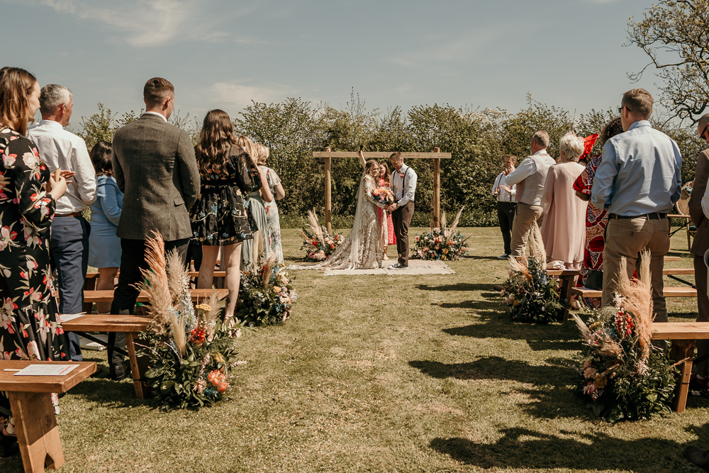 Ceremony Arch Backdrop Flowers Rug Decor Bohemian Tipi Wedding MattMoore Photography