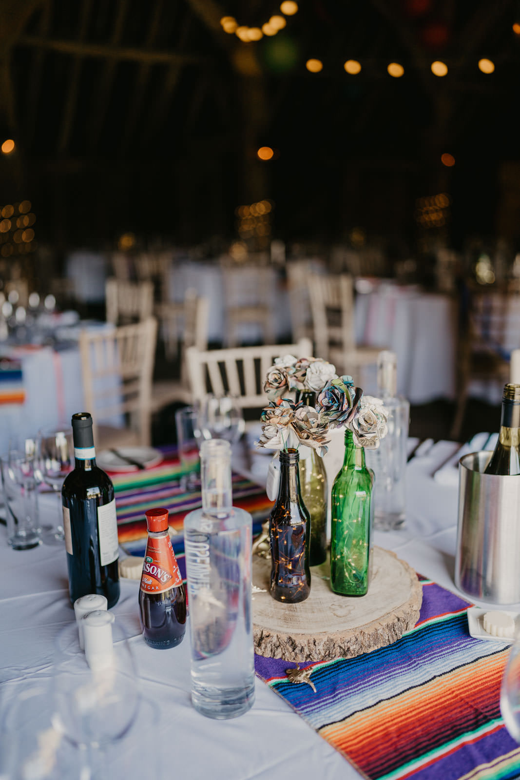 Centrepiece Table Decor Paper Flowers Bottles Log Slice Bright Barn Wedding Kim Williams Weddings