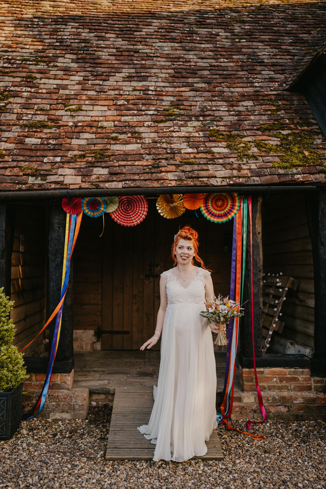 Dress Gown Bride Bridal Maternity Pregnant Colourful Paper Pinwheels Decor Ribbon Backdrop Streamer Bright Barn Wedding Kim Williams Weddings