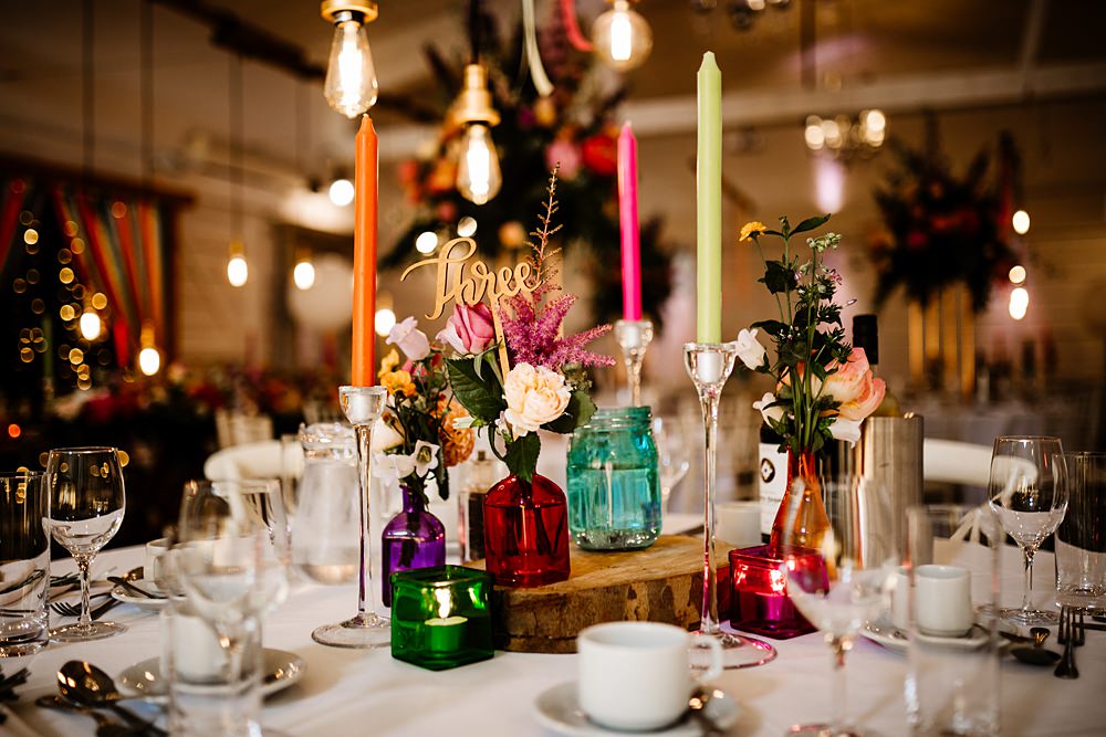Colourful Candles Flowers Centrepiece Glassware Log Slice Lancashire Barn Wedding Beth Alderson Photography