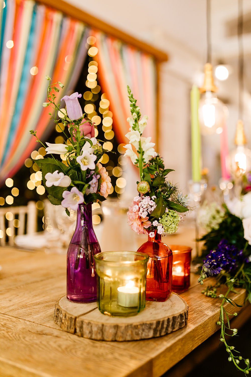 Colourful Candles Flowers Centrepiece Glassware Log Slice Lancashire Barn Wedding Beth Alderson Photography