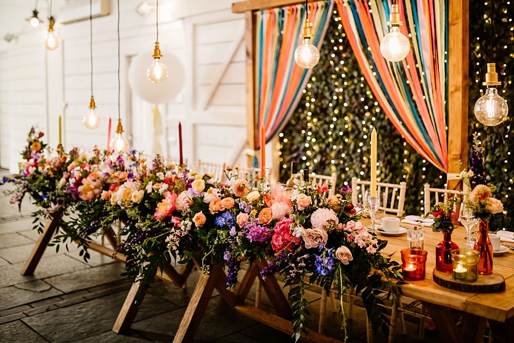 Top Table Colourful Ribbon Backdrop Festoon Lights Colourful Flowers Runner Lancashire Barn Wedding Beth Alderson Photography
