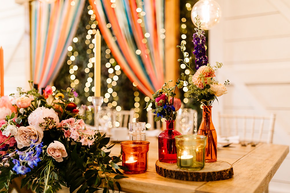 Colourful Candles Flowers Centrepiece Glassware Log Slice Lancashire Barn Wedding Beth Alderson Photography
