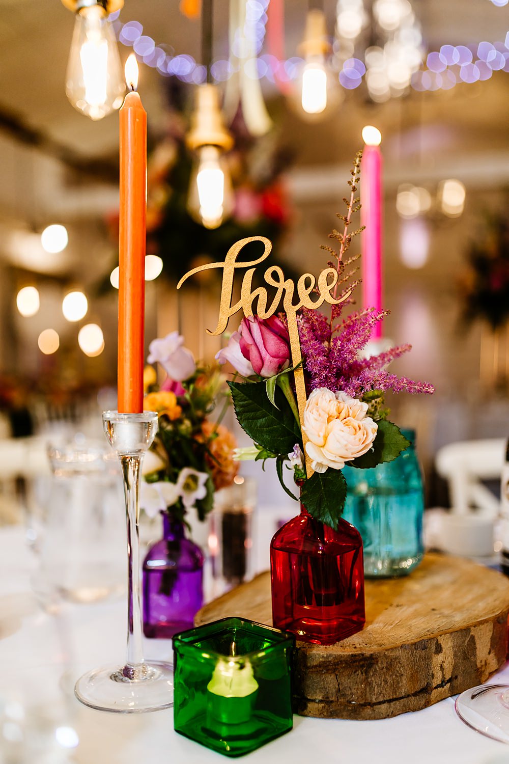 Colourful Candles Flowers Centrepiece Glassware Log Slice Table Number Lancashire Barn Wedding Beth Alderson Photography