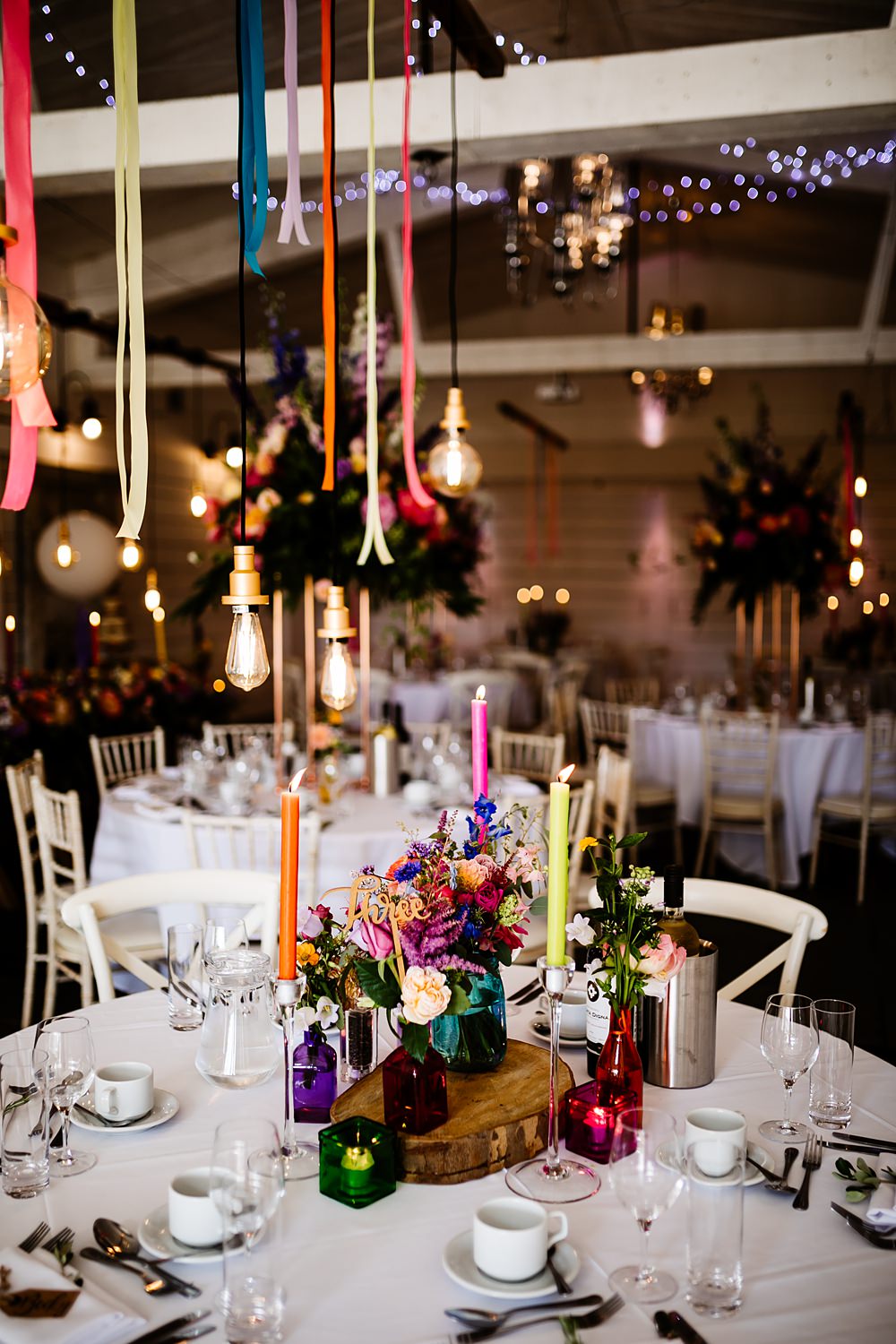 Colourful Candles Flowers Centrepiece Glassware Log Slice Lancashire Barn Wedding Beth Alderson Photography