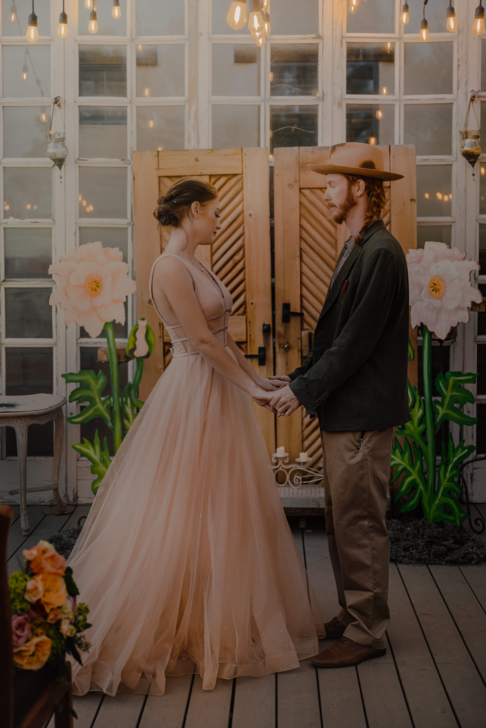 Door Backdrop Large Paper Flowers Festoon Lights Ceremony Aisle Wizard Oz Emerald City Wedding Claire Gutierrez Photography