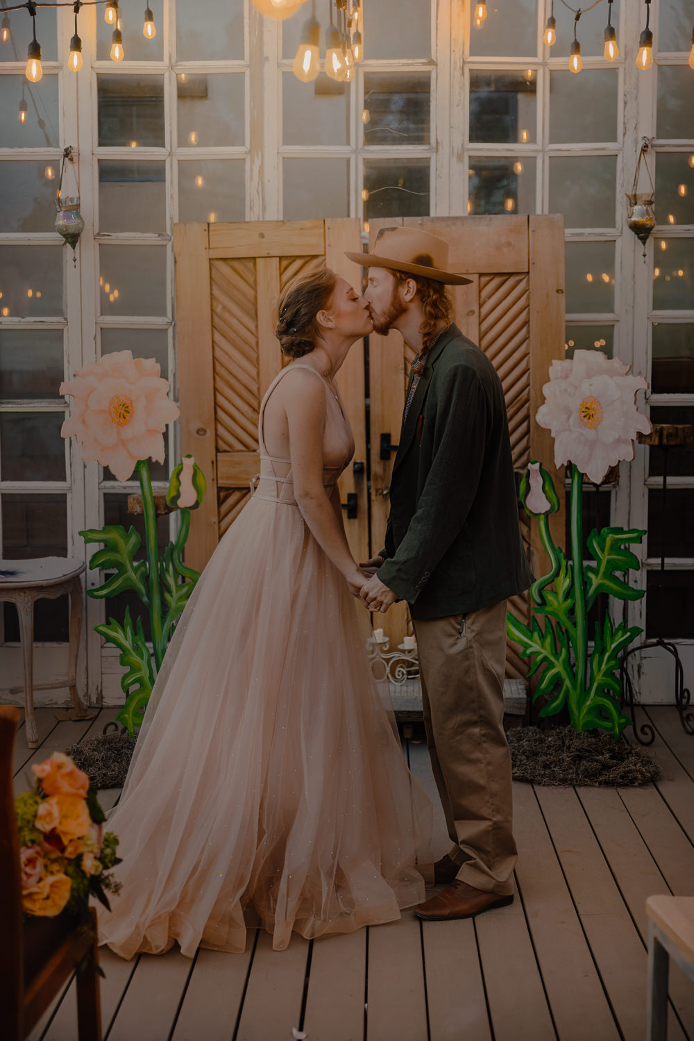 Door Backdrop Large Paper Flowers Festoon Lights Ceremony Aisle Wizard Oz Emerald City Wedding Claire Gutierrez Photography