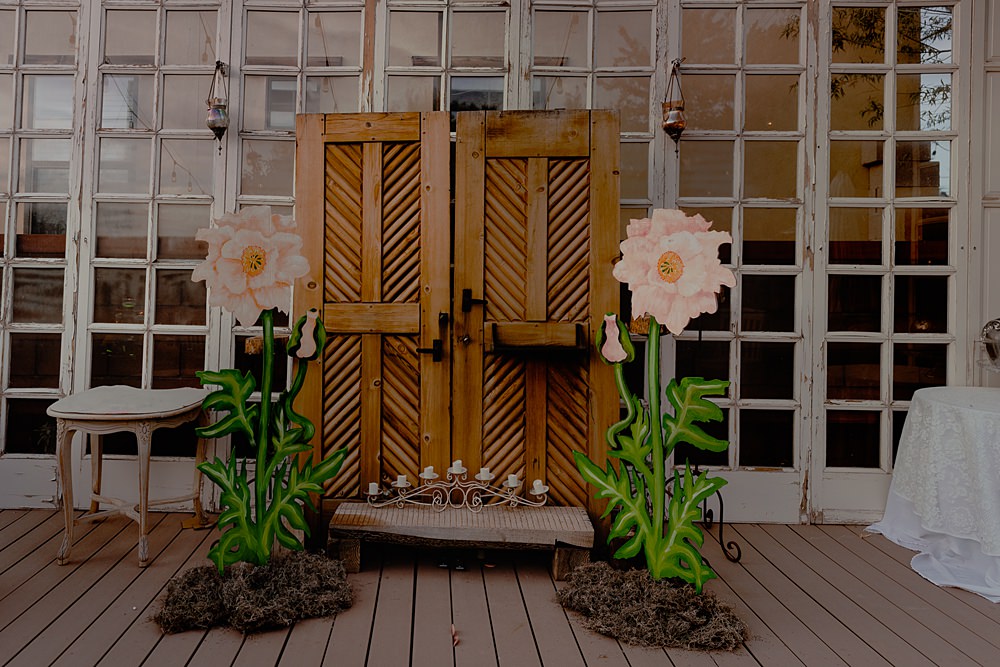 Door Backdrop Large Paper Flowers Festoon Lights Ceremony Aisle Wizard Oz Emerald City Wedding Claire Gutierrez Photography