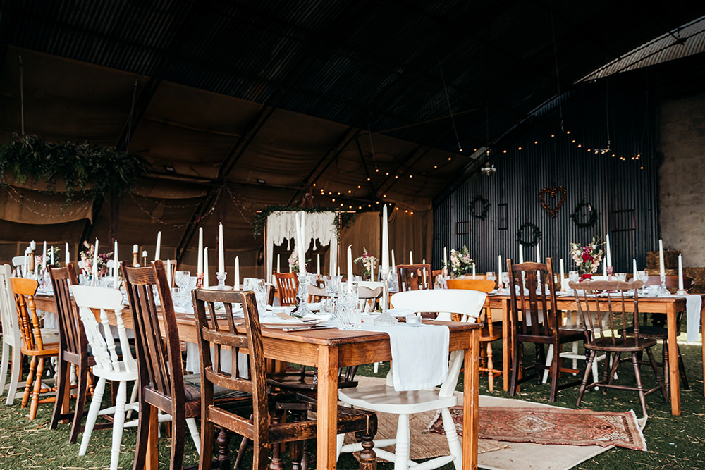 Mismatched Chairs Wooden Tables Decor Aircraft Hangar Wedding Sherri OMalley Photography