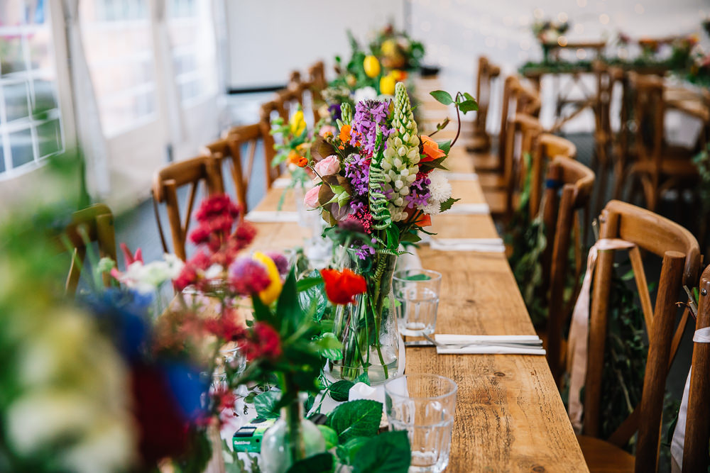 Long Wooden Tables Colourful Flowers Greenery Decor Centrepiece Beauvale Priory Wedding Lisa Marie Halliday