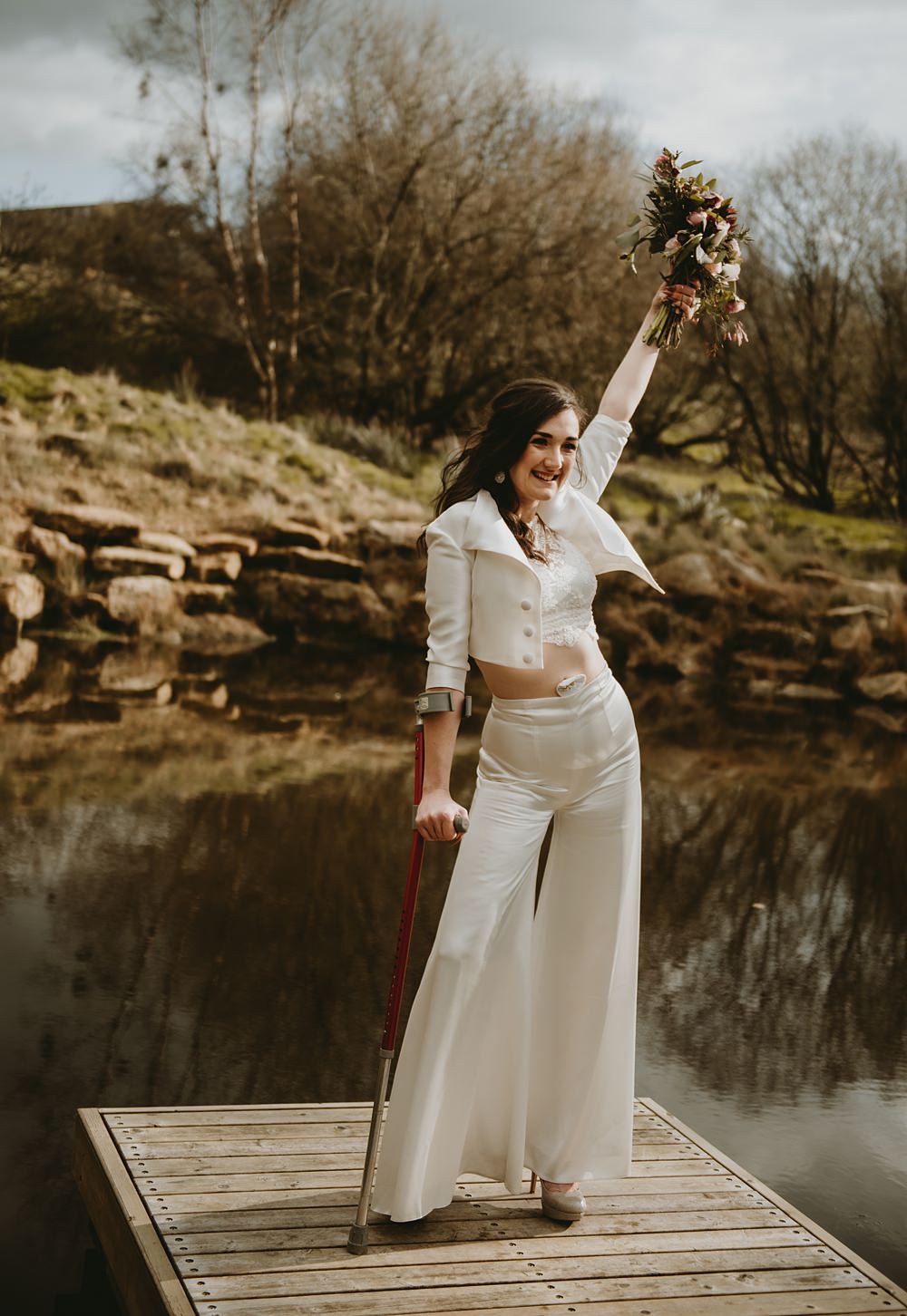 Bride Trousers Top Jacket Crutches Little Seed Field Wedding Louise Pollitt Photography
