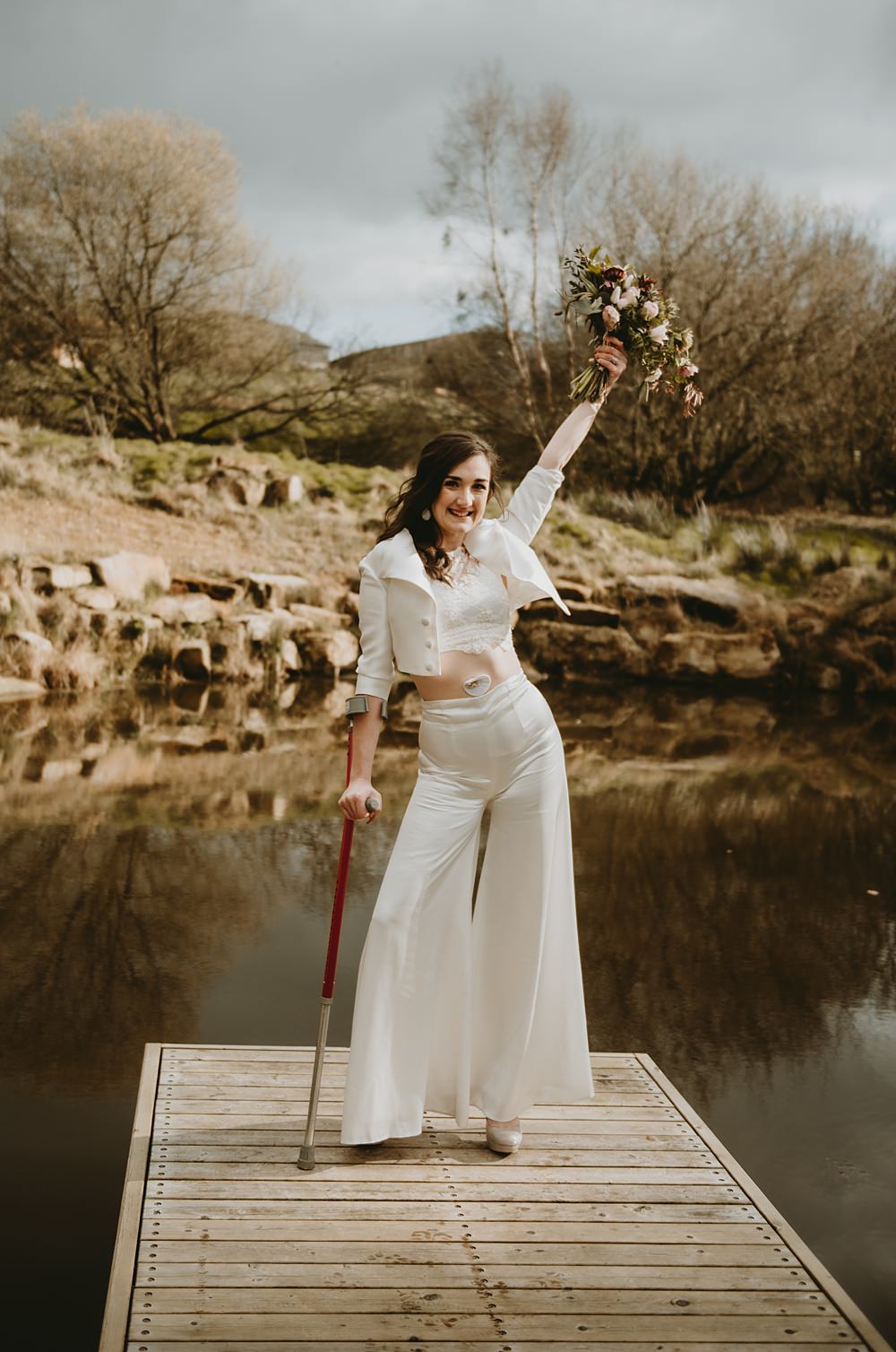 Bride Trousers Top Jacket Crutches Little Seed Field Wedding Louise Pollitt Photography