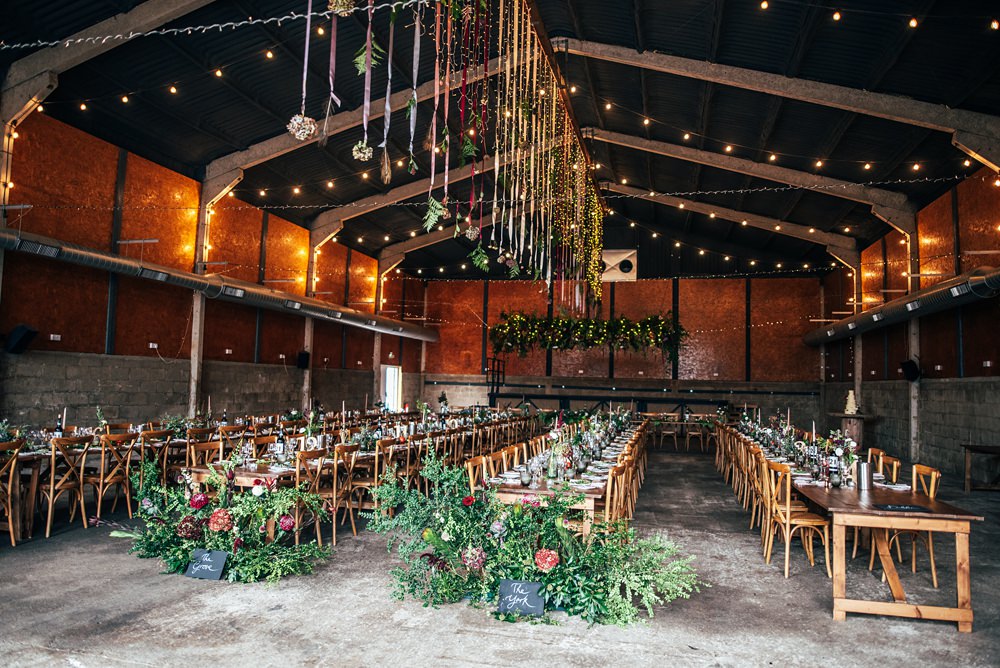 Barn Decor Hanging Flowers Long Tables Wooden Red Greenery Wedding Three Flowers Photography