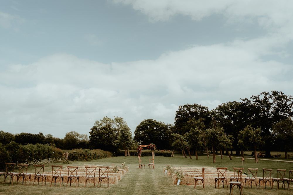 Outdoor Ceremony Wooden Chairs Flower Arch Sri Lankan English Wedding Patrick Partridge Photography
